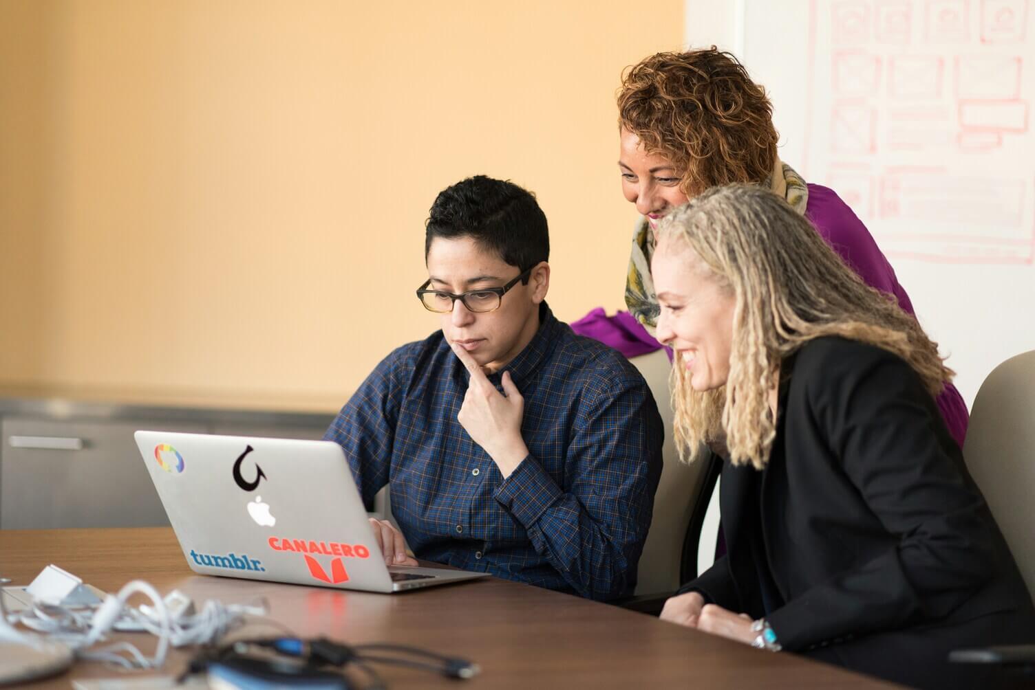 Team collaborating at a table in an open office